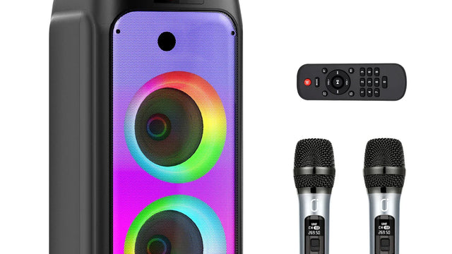 Enceinte karaoké lumineuse noire sur roulettes avec poignée orange, anneaux de lumière colorés, télécommande et deux micros sans fil