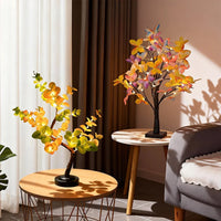 Arbre lumineux bonsaï – eucalyptus et papillons allumés dans un salon