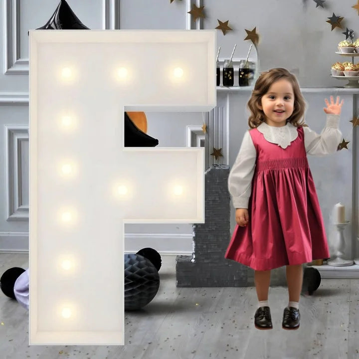 Lettre marquee 120 cm – la lettre F allumée à côté d'une petite fille
