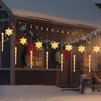 Rideau lumineux flocons et glaçons de Noël – rideau lumineux sur une façade enneigée