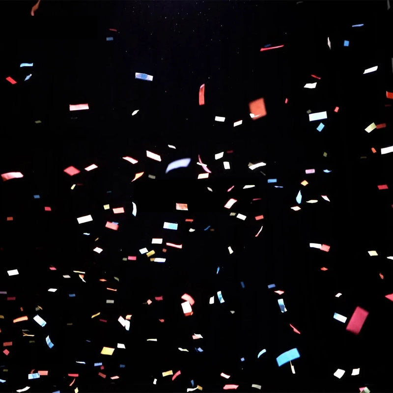 Pluie de confettis multicolores sur fond noir