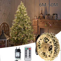 Guirlande lumineuse pétard LED – bobine avec adaptateur et télécommande devant un sapin de Noël