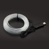 Bande lumineuse fibre optique – câble enroulé et boîtier USB sur fond sombre
