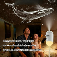 Projecteur galaxie 2 en 1 tactile – baleine céleste projetée au plafond, un adulte et un enfant sur un lit, légende en anglais