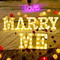 Lettres et chiffres lumineux LED à piles – MARRY ME en lettres lumineuses sur un lit