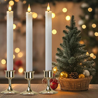 Bougies LED coniques – bougies sur chandeliers dorés devant un sapin de Noël