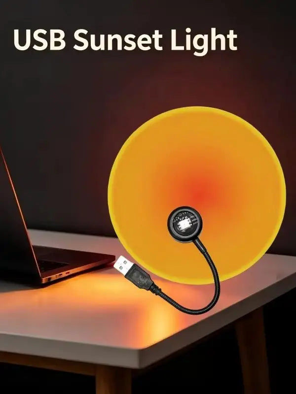 Lampe coucher de soleil USB à col flexible – projection jaune sur un bureau près d'un ordinateur